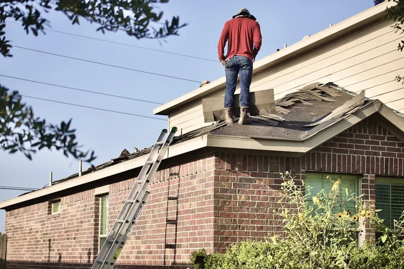 Professional roofer working on a residential roof in Emery Corners